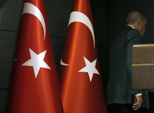Turkish President Recep Tayyip Erdogan leaves after giving a statement